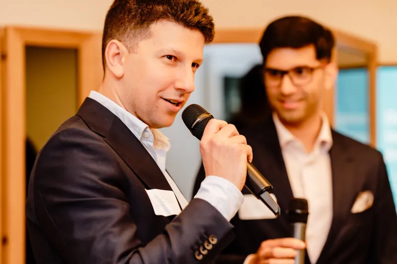Dr Joshua Hurwitz speaking with a microphone at The Art of Breast Cancer education event